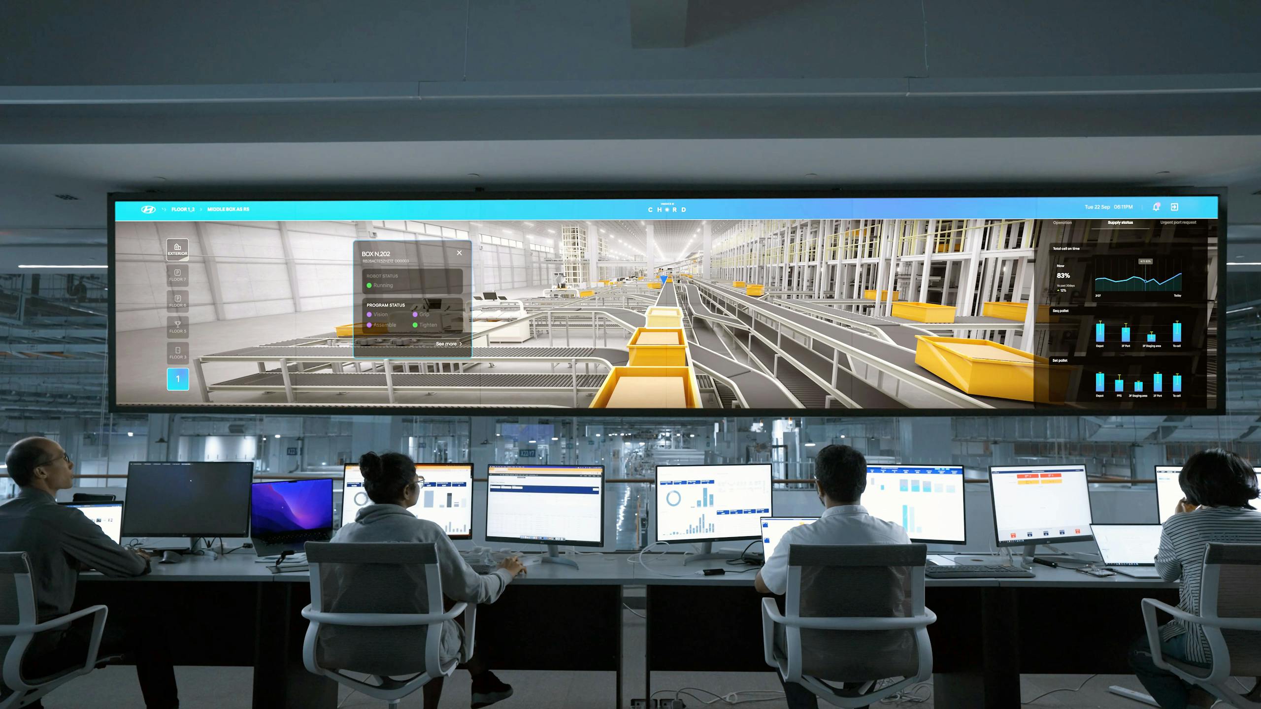 Manufacturing 11 Modern control room with people monitoring large digital displays and computer systems.